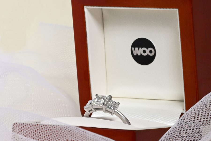 Three stone engagement ring presented in a Woo by Design wooden ring box