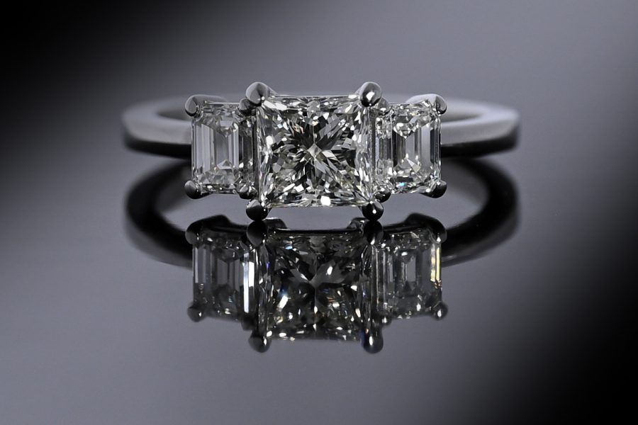 Front view shot of a princess cut diamond & platinum engagement ring.